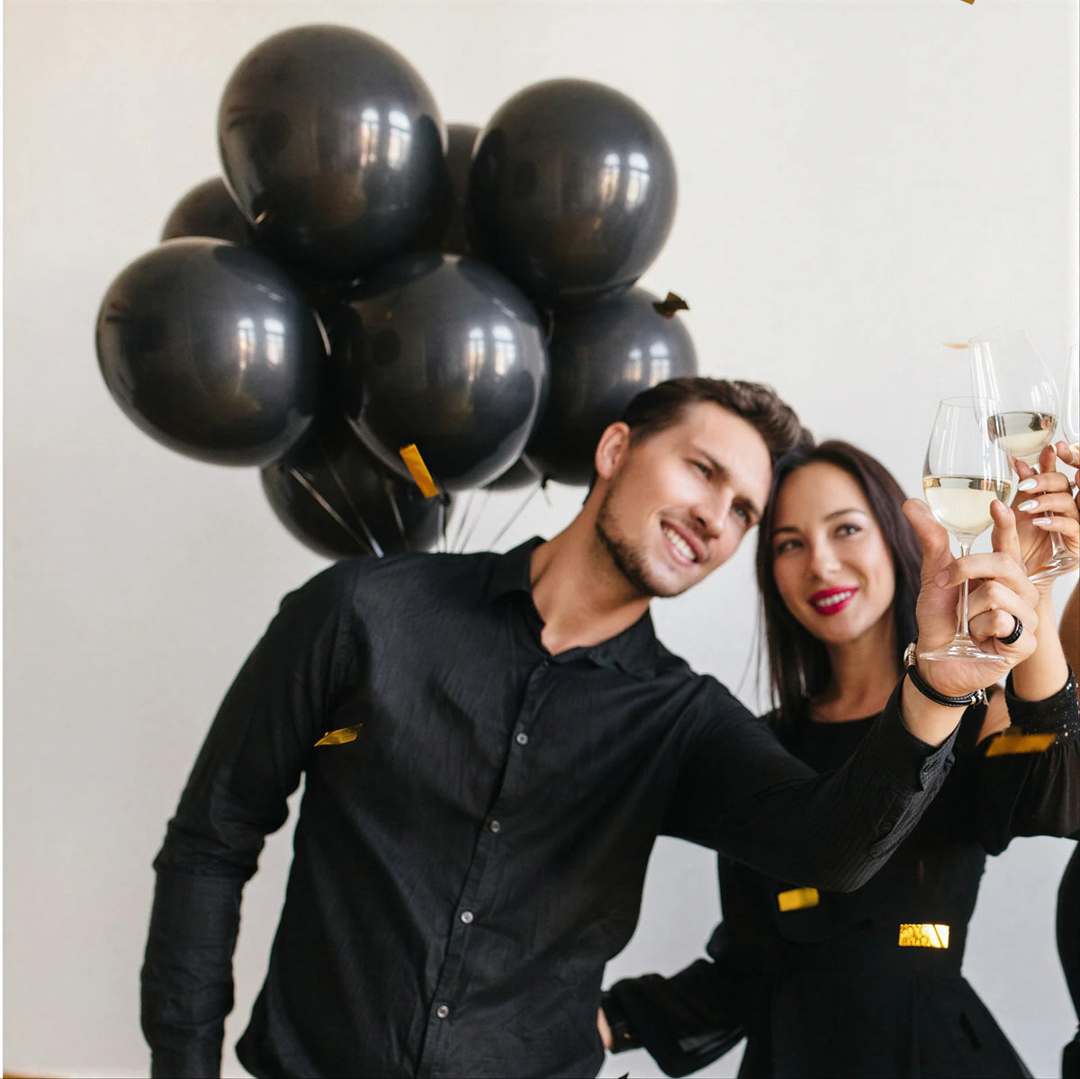 Graduates celebrating with black balloons