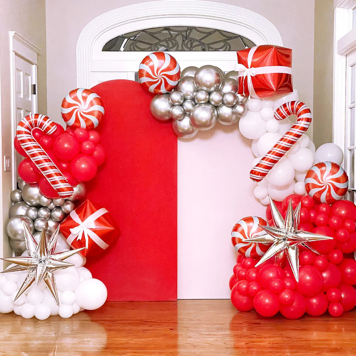 Red and white Christmas balloon arch with snowman, candy cane and star balloons